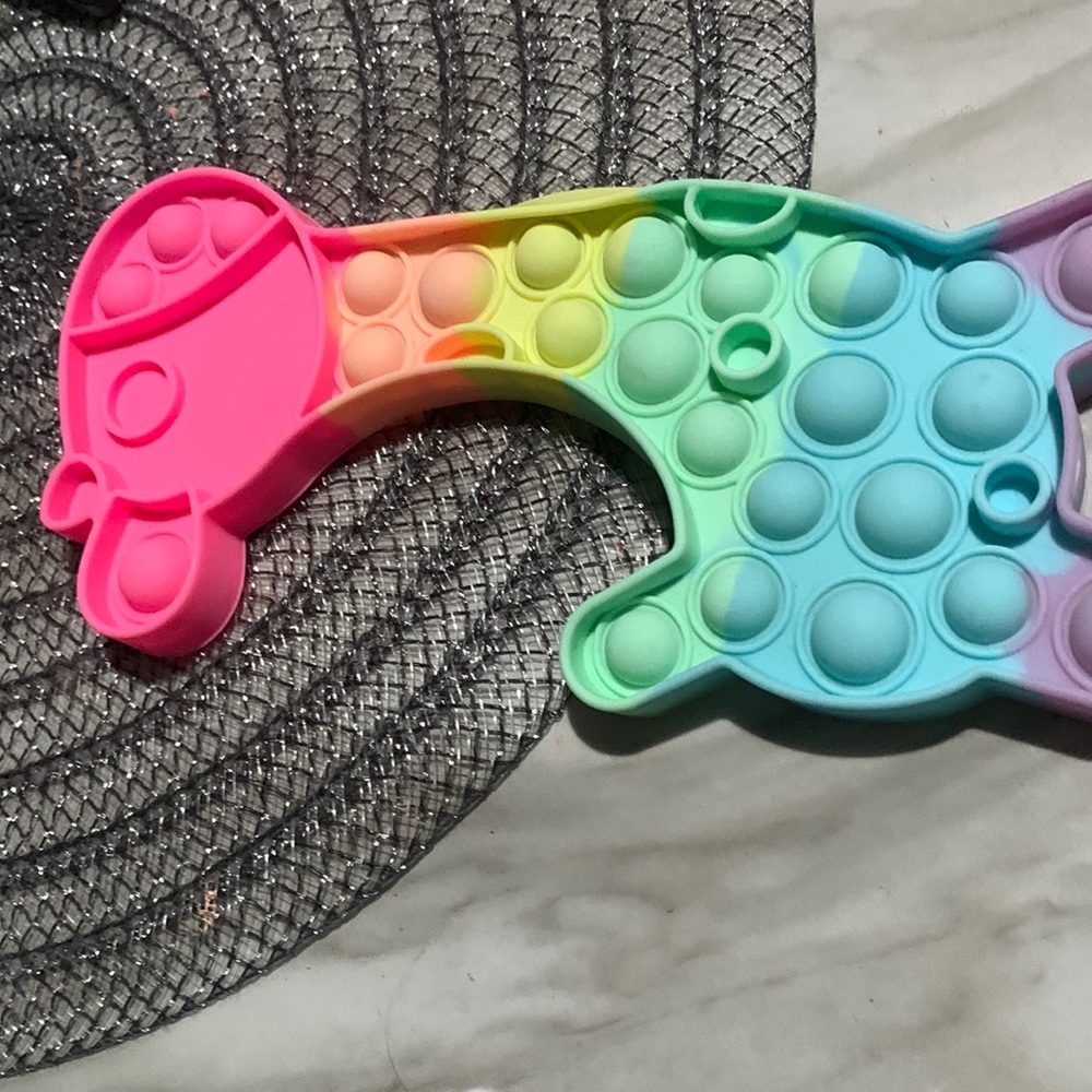I’m selling a rainbow Giraffe pop it